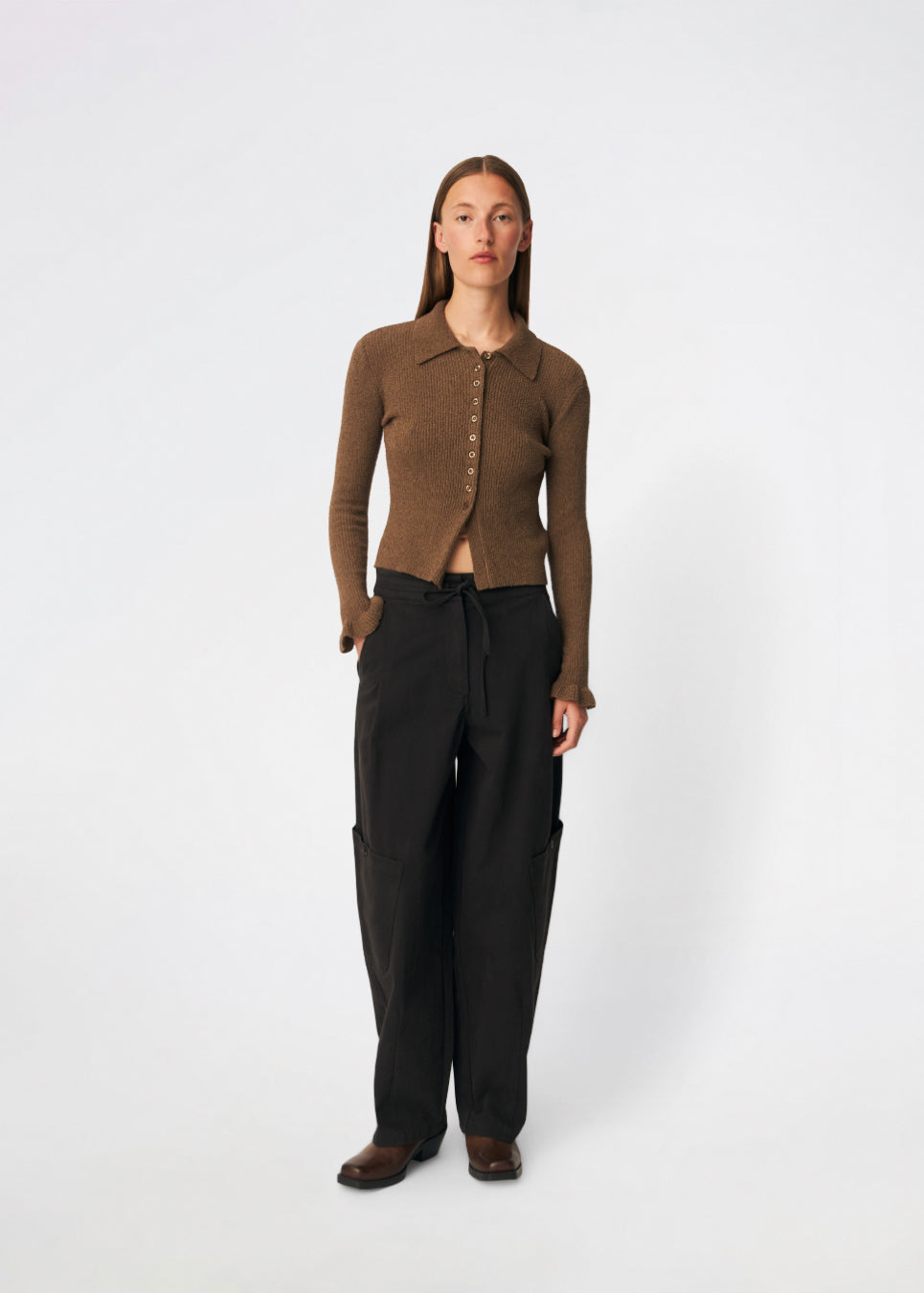 Feminine rib-knit cardigan with elegant details. Corneliamd cardigan is designed in a fitted silhouette with a classic collar, full button-front closure, and delicate ruffle trims at the cuffs. The soft rib-knit enhances the flattering fit, making it a versatile wardrobe staple that can be worn buttoned up as a knit top or layered open over a camisole or dress.