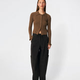 Feminine rib-knit cardigan with elegant details. Corneliamd cardigan is designed in a fitted silhouette with a classic collar, full button-front closure, and delicate ruffle trims at the cuffs. The soft rib-knit enhances the flattering fit, making it a versatile wardrobe staple that can be worn buttoned up as a knit top or layered open over a camisole or dress.