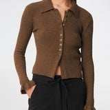 Feminine rib-knit cardigan with elegant details. Corneliamd cardigan is designed in a fitted silhouette with a classic collar, full button-front closure, and delicate ruffle trims at the cuffs. The soft rib-knit enhances the flattering fit, making it a versatile wardrobe staple that can be worn buttoned up as a knit top or layered open over a camisole or dress.