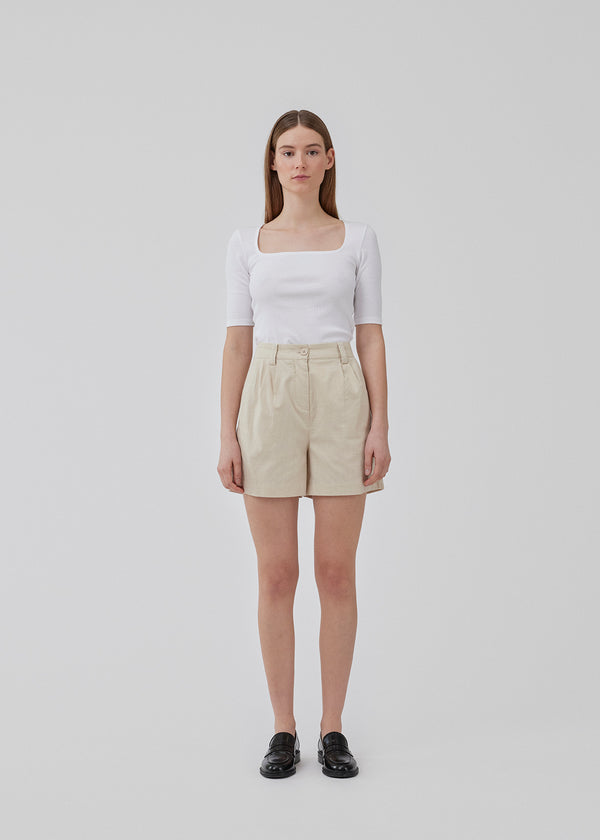 Cotton shorts in beige with wide legs. CydneyMD shorts has a tailormade look with pleats in front and paspoil pockets in back.
