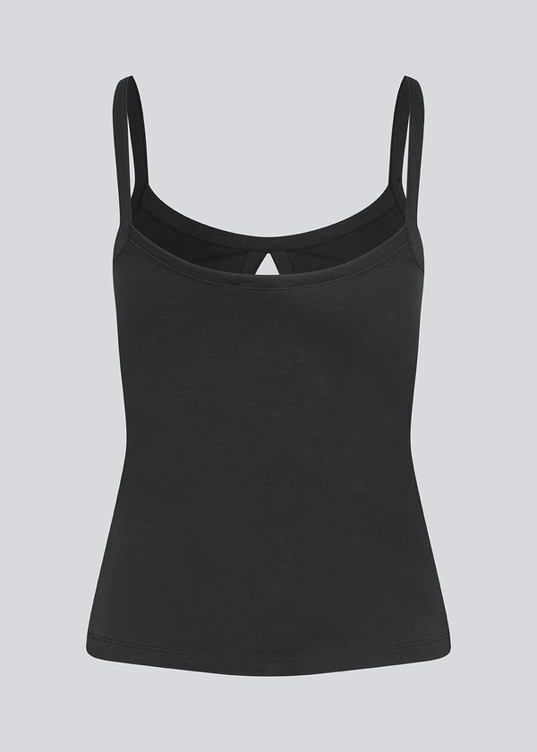 Fitted black top with an opening at the chest and a slit in front. DaeMD strap top is made from a rib knitted organic cotton.&nbsp;