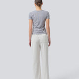 Tight fit basic top with a high and straight neckline in grey. DaeMD top is made from a rib-knit organic cotton. The model is 177 cm and wears a size S/36.