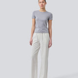 Tight fit basic top with a high and straight neckline in grey. DaeMD top is made from a rib-knit organic cotton. The model is 177 cm and wears a size S/36.