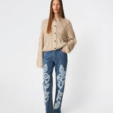 DahliaMD Cardigan is a short cardigan with a relaxed fit and round neckline. The design features a full button fastening, long sleeves and decorative knitted details at the front and along the sleeves. Style it with jeans or classic trousers for a relaxed everyday look. The model is 175 cm tall and is wearing a size S/36.