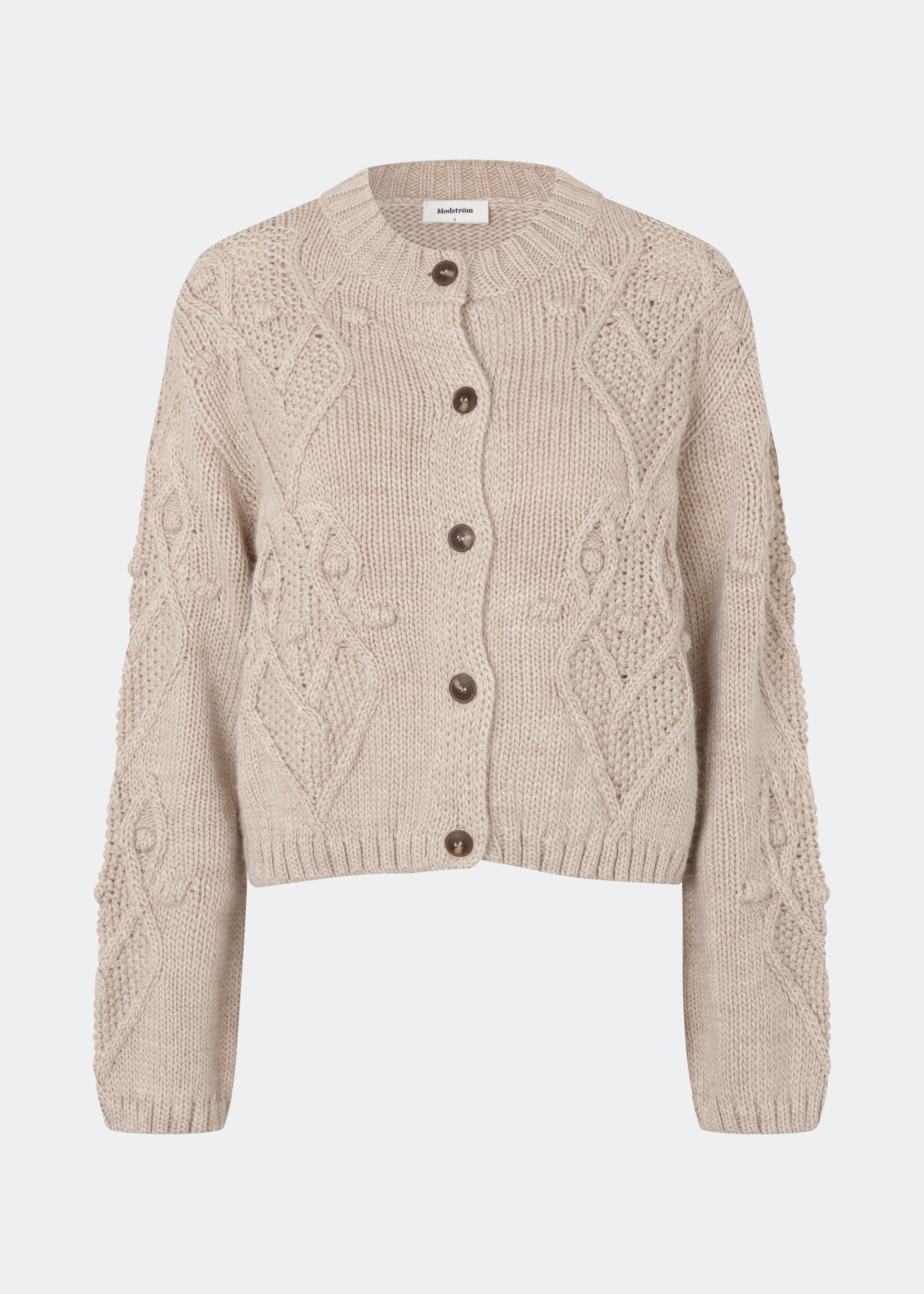 DahliaMD Cardigan is a short cardigan with a relaxed fit and round neckline. The design features a full button fastening, long sleeves and decorative knitted details at the front and along the sleeves. Style it with jeans or classic trousers for a relaxed everyday look. The model is 175 cm tall and is wearing a size S/36.