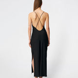 DanillaMD Dress is a long satin dress with an elegant, figure-hugging silhouette. The design features a straight neckline, thin straps and draped detailing at the side, creating a soft fall. The open back with delicate crossing straps adds a feminine touch. Style it with heels and simple accessories for special occasions. The model is 175 cm tall and is wearing a size S/36.
