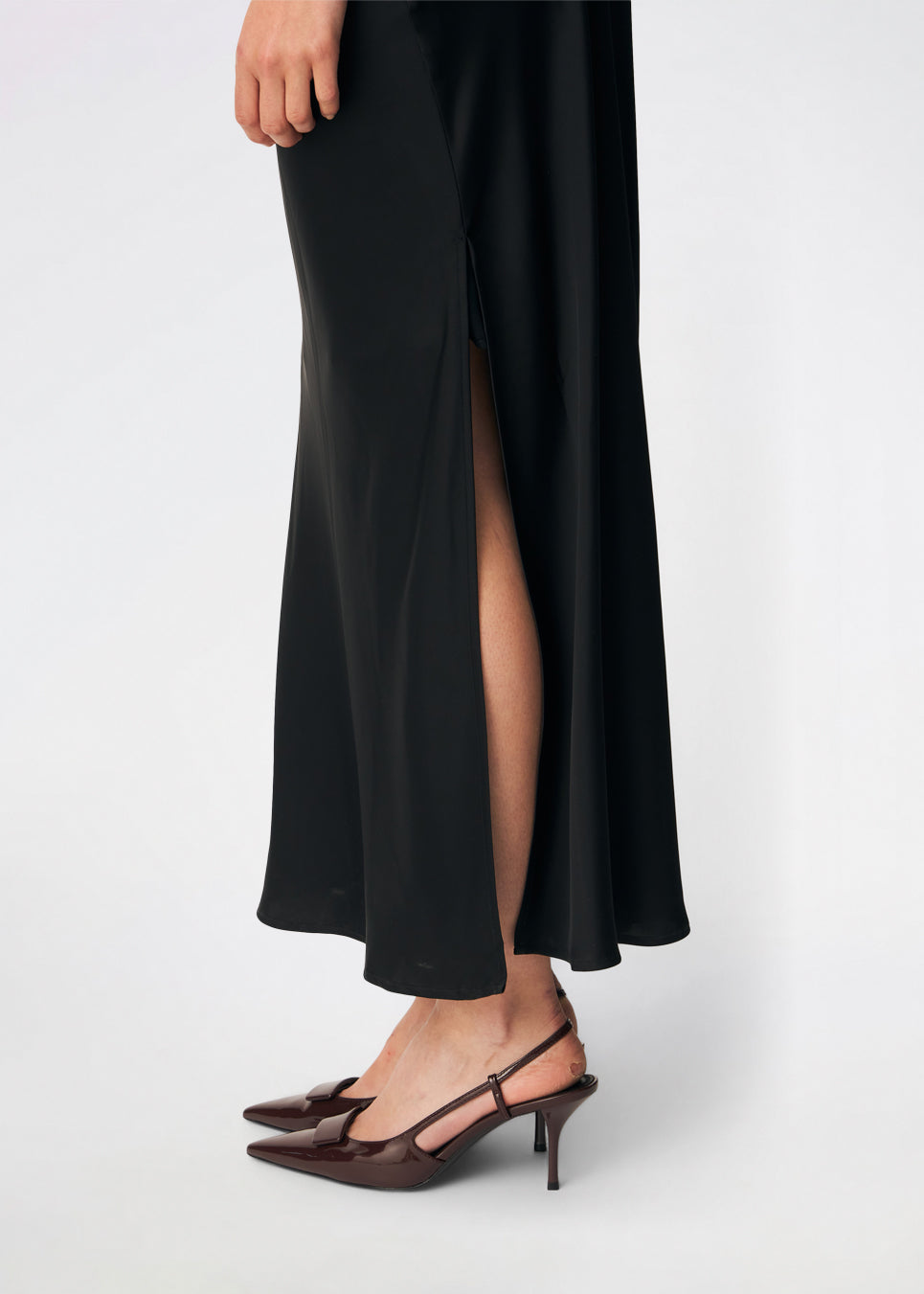 DanillaMD Dress is a long satin dress with an elegant, figure-hugging silhouette. The design features a straight neckline, thin straps and draped detailing at the side, creating a soft fall. The open back with delicate crossing straps adds a feminine touch. Style it with heels and simple accessories for special occasions. The model is 175 cm tall and is wearing a size S/36.