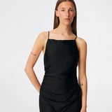 DanillaMD Dress is a long satin dress with an elegant, figure-hugging silhouette. The design features a straight neckline, thin straps and draped detailing at the side, creating a soft fall. The open back with delicate crossing straps adds a feminine touch. Style it with heels and simple accessories for special occasions. The model is 175 cm tall and is wearing a size S/36.