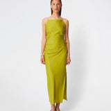 DanillaMD Dress is a long satin dress with an elegant, figure-hugging silhouette. The design features a straight neckline, thin straps and draped detailing at the side, creating a soft fall. The open back with delicate crossing straps adds a feminine touch. Style it with heels and simple accessories for special occasions. The model is 175 cm tall and is wearing a size S/36.