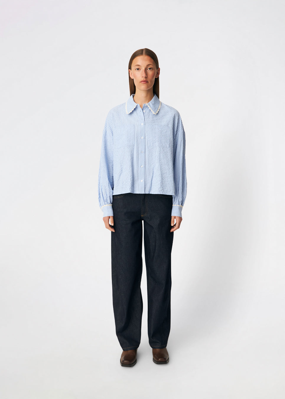 DanjaMD Shirt is a striped shirt with a relaxed fit and long sleeves. The design features a classic shirt collar with decorative lace trim, a button-down front and two chest pockets. Lace trims at the cuffs add a feminine contrast to the classic striped look. Style it with jeans or tailored trousers for an everyday look. The model is 175 cm tall and is wearing a size S/36.