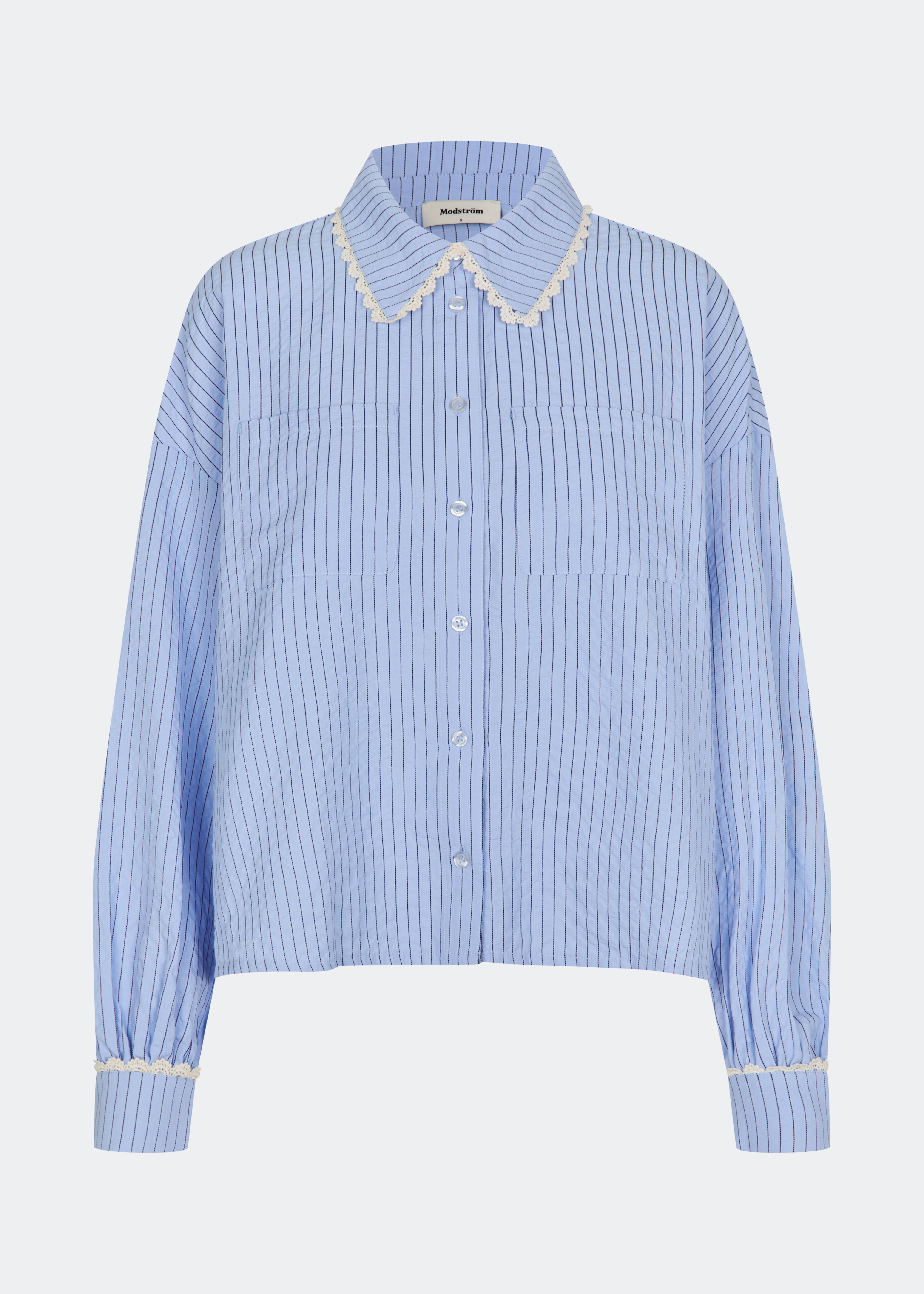 DanjaMD Shirt is a striped shirt with a relaxed fit and long sleeves. The design features a classic shirt collar with decorative lace trim, a button-down front and two chest pockets. Lace trims at the cuffs add a feminine contrast to the classic striped look. Style it with jeans or tailored trousers for an everyday look. The model is 175 cm tall and is wearing a size S/36.