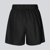 Shorts in black in a relaxed fit, wide legs, and an elasticated waistband. DarrelMD shorts are crafted from a linen material. The model is 177 cm and wears a size S/36.