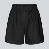 Shorts in black in a relaxed fit, wide legs, and an elasticated waistband. DarrelMD shorts are crafted from a linen material. The model is 177 cm and wears a size S/36.