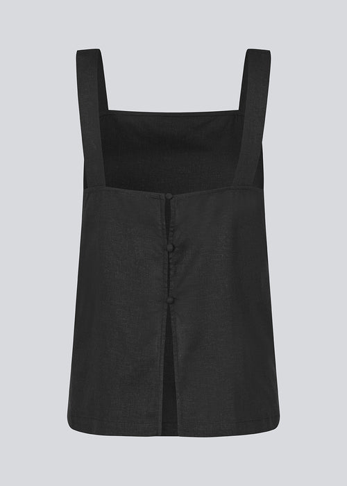 Black Top with wide straps and a loose fit. DarrelMD top has a slit in the back and is closed with three buttons.