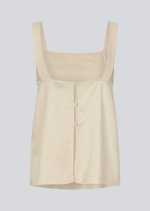 Linen top in beige with wide straps and a loose fit. DarrelMD top has a slit in the back and is closed with three buttons.