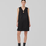 Short black linen dress with an A-line silhouette. DaynaMD dress is sleeveless, and features a deep v-neckline with cut-out details and ties. The model is 177 cm and wears a size S/36.