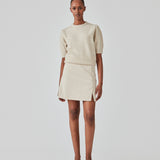 Short skirt with a medium waistline. DaynaMD skirt is made with a slim fit with wrap-over detail with a small slit in front and zipper at the side. The model is 177 cm and wears a size S/36.