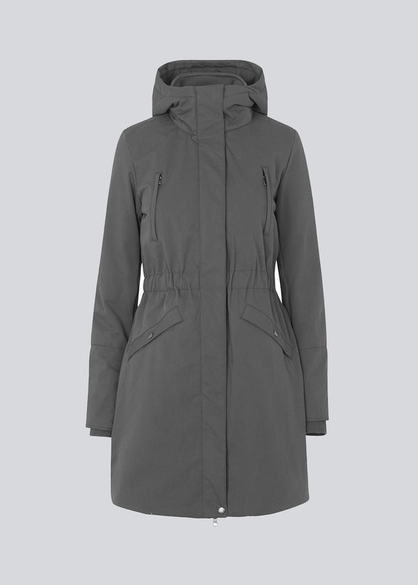 Denise coat in grey has a hood, fitted at the waist and has hidden zipper closure at front. The jacket has 4 pockets and is lined with Thermolite polyester padding, which is recognized for its high insulation and therefore is the perfect choice for the cold winters.