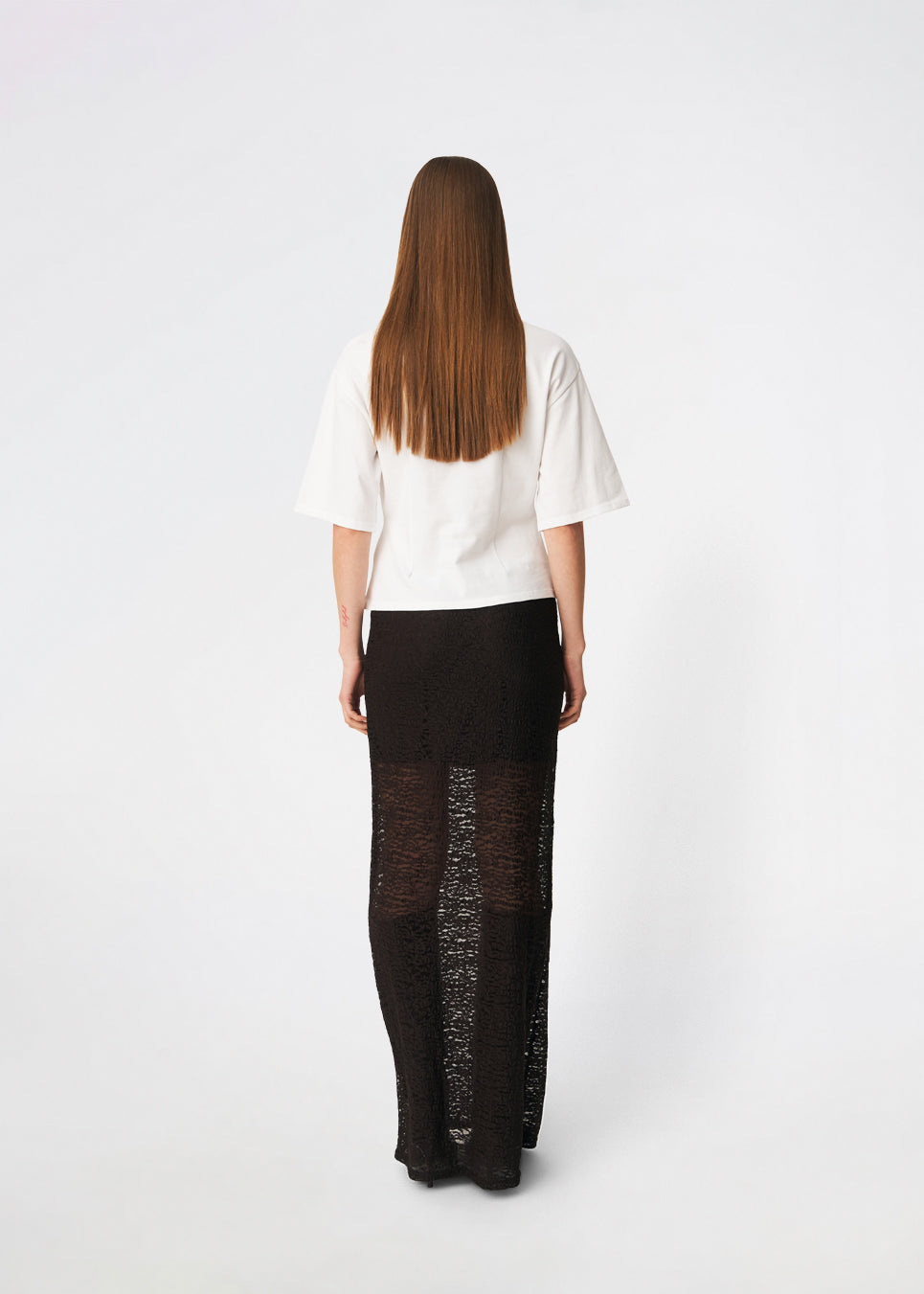 Dianamd Skirt is an elegant maxi skirt with a fitted silhouette through the hips, flowing into a sheer lace design from the knees down. The long, streamlined shape creates a feminine silhouette, while the semi-sheer finish adds a light and sophisticated touch. Style it with a simple T-shirt for an effortless everyday look or pair it with an elegant top for special occasions. The model is 175 cm tall and is wearing a size S/36.