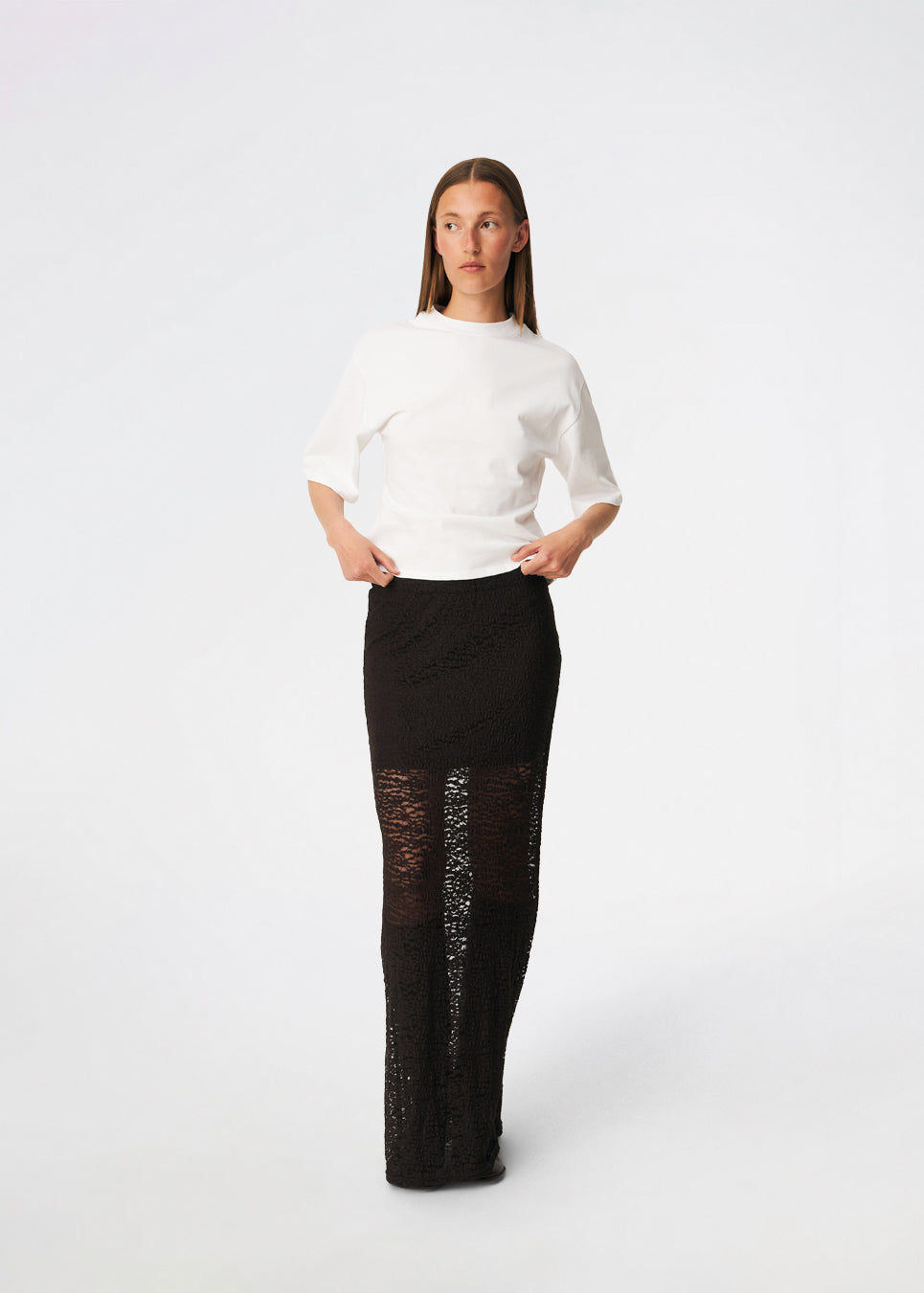 Dianamd Skirt is an elegant maxi skirt with a fitted silhouette through the hips, flowing into a sheer lace design from the knees down. The long, streamlined shape creates a feminine silhouette, while the semi-sheer finish adds a light and sophisticated touch. Style it with a simple T-shirt for an effortless everyday look or pair it with an elegant top for special occasions. The model is 175 cm tall and is wearing a size S/36.