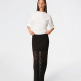 Dianamd Skirt is an elegant maxi skirt with a fitted silhouette through the hips, flowing into a sheer lace design from the knees down. The long, streamlined shape creates a feminine silhouette, while the semi-sheer finish adds a light and sophisticated touch. Style it with a simple T-shirt for an effortless everyday look or pair it with an elegant top for special occasions. The model is 175 cm tall and is wearing a size S/36.