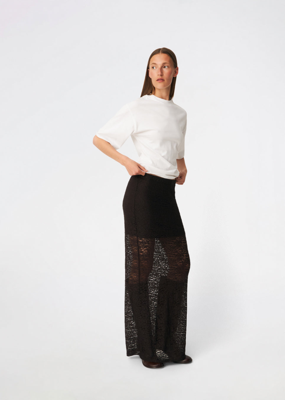Dianamd Skirt is an elegant maxi skirt with a fitted silhouette through the hips, flowing into a sheer lace design from the knees down. The long, streamlined shape creates a feminine silhouette, while the semi-sheer finish adds a light and sophisticated touch. Style it with a simple T-shirt for an effortless everyday look or pair it with an elegant top for special occasions. The model is 175 cm tall and is wearing a size S/36.