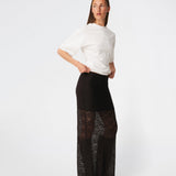 Dianamd Skirt is an elegant maxi skirt with a fitted silhouette through the hips, flowing into a sheer lace design from the knees down. The long, streamlined shape creates a feminine silhouette, while the semi-sheer finish adds a light and sophisticated touch. Style it with a simple T-shirt for an effortless everyday look or pair it with an elegant top for special occasions. The model is 175 cm tall and is wearing a size S/36.
