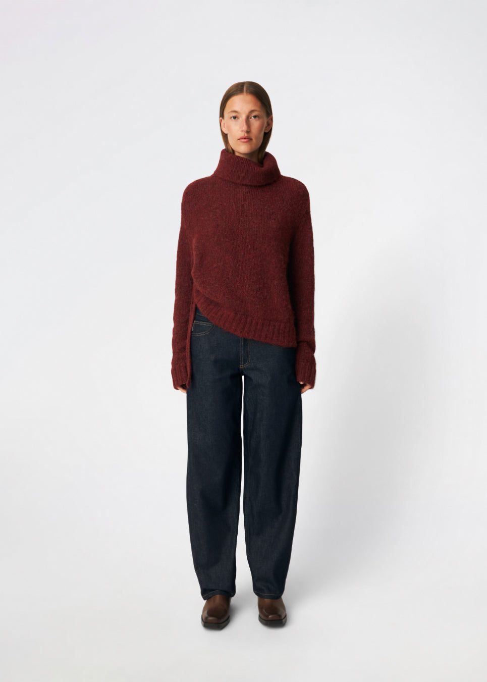 The Dictemd Rollneck is a soft knit sweater featuring a high roll neck and a relaxed fit. Ribbed trims and a subtle side slit add a modern touch, while the melange knit provides warmth and texture. A versatile wardrobe staple, perfect worn on its own or layered under seasonal jackets and coats.