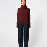 The Dictemd Rollneck is a soft knit sweater featuring a high roll neck and a relaxed fit. Ribbed trims and a subtle side slit add a modern touch, while the melange knit provides warmth and texture. A versatile wardrobe staple, perfect worn on its own or layered under seasonal jackets and coats.