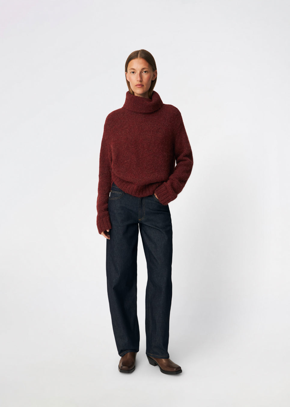 The Dictemd Rollneck is a soft knit sweater featuring a high roll neck and a relaxed fit. Ribbed trims and a subtle side slit add a modern touch, while the melange knit provides warmth and texture. A versatile wardrobe staple, perfect worn on its own or layered under seasonal jackets and coats.