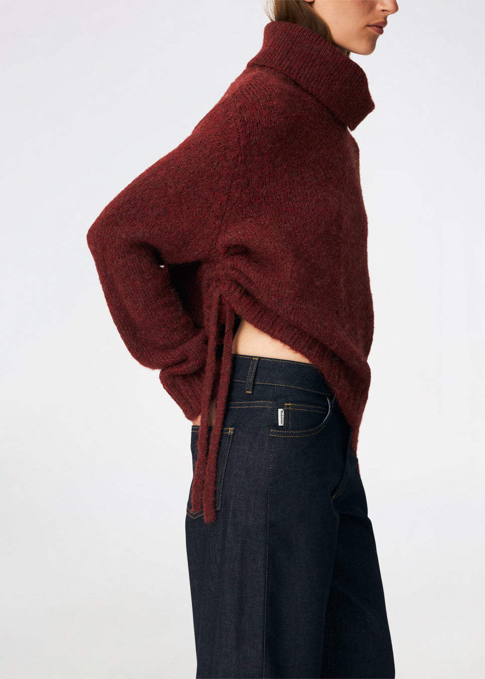 The Dictemd Rollneck is a soft knit sweater featuring a high roll neck and a relaxed fit. Ribbed trims and a subtle side slit add a modern touch, while the melange knit provides warmth and texture. A versatile wardrobe staple, perfect worn on its own or layered under seasonal jackets and coats.