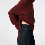 The Dictemd Rollneck is a soft knit sweater featuring a high roll neck and a relaxed fit. Ribbed trims and a subtle side slit add a modern touch, while the melange knit provides warmth and texture. A versatile wardrobe staple, perfect worn on its own or layered under seasonal jackets and coats.