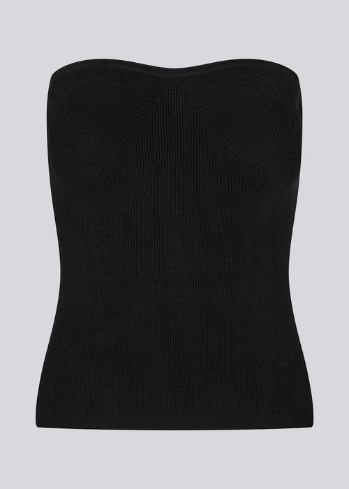 Black tube top with fitted shape and sweetheart neckline. DiegoMD top is made from a soft, ribbed knit with a silicone band on the inside of the neckline. The model is 177 cm and wears a size S/36.