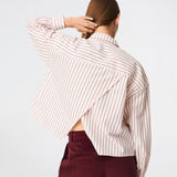The Dilanmd Stripe Shirt is a classic striped shirt with a relaxed oversized fit. Designed with a traditional collar, button closure, and wide cuffs, it is finished with a distinctive overlapping back slit that adds a modern twist. A versatile wardrobe staple that can be worn on its own or layered effortlessly over everyday essentials.