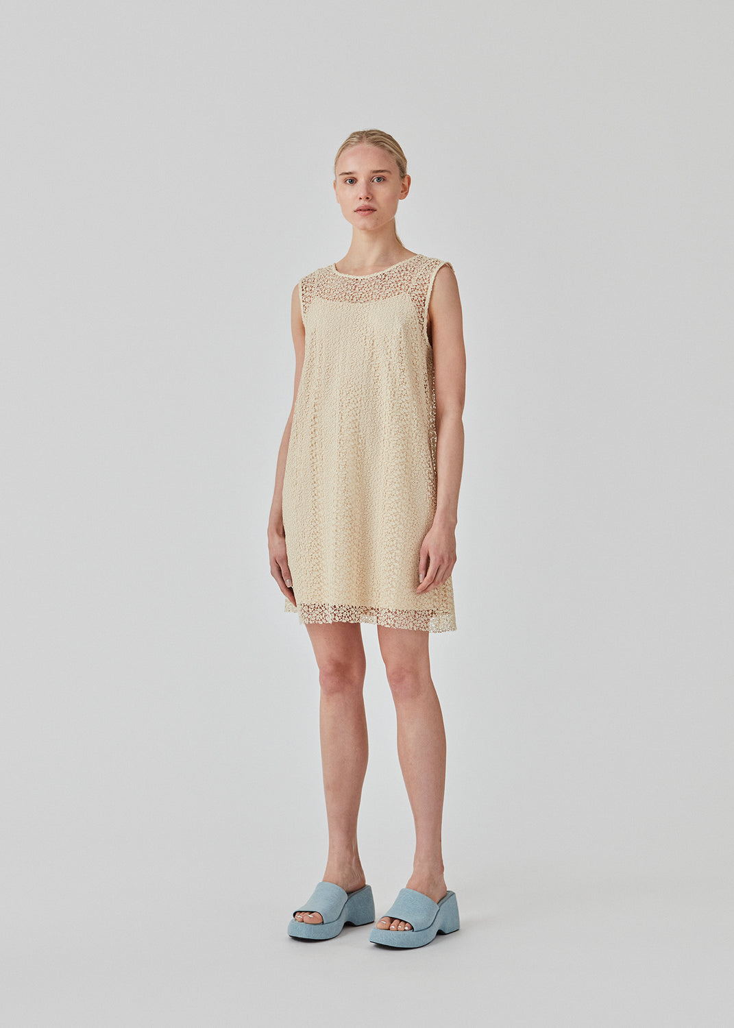 Sleeveless dress in a short length cut from a lace material. DionaMD dress has a round neck in front and a deep neckline in the back. The model is 177 cm and wears a size S/36.