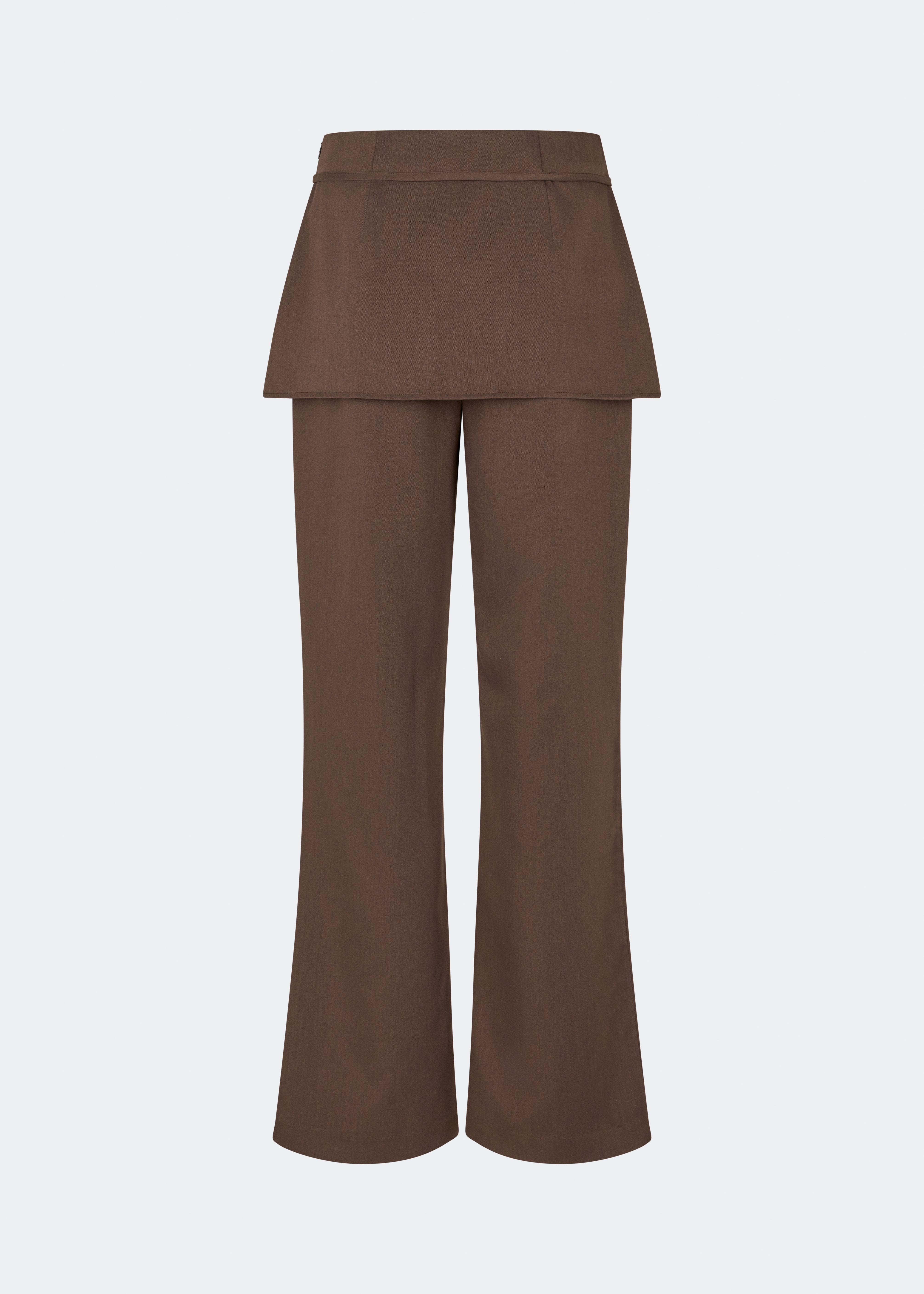 The Dodomd Pants feature a straight-leg silhouette with an integrated skirt overlay that creates a modern, statement look. A slim waist strap with a metal buckle adds a refined finishing touch, while the clean tailoring makes them easy to style. Pair them with the matching Dodomd Top or a simple knit for an elevated everyday outfit.