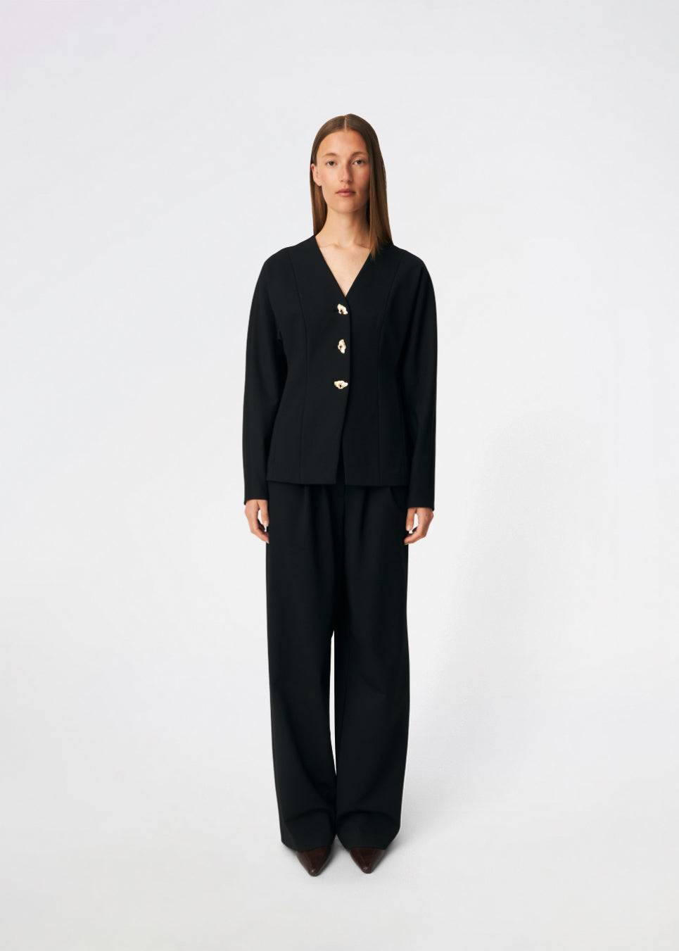 The Doritmd Blazer is a feminine tailored blazer with a clean collarless neckline and a fitted silhouette. Sculptural gold-tone buttons add a refined statement, while the shaped panels accentuate the waist for a flattering fit. Wear it with the matching trousers or layer it over a dress for a modern, sophisticated look.