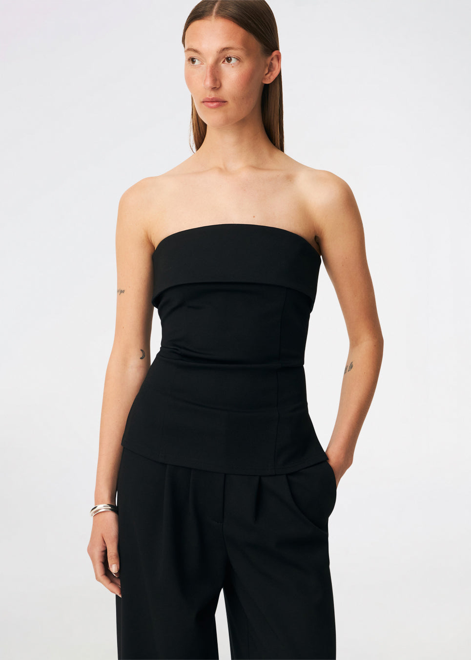 The Doritmd Top is an elegant strapless top with a fitted silhouette and a distinctive fold-over neckline for a modern, sophisticated look. Shaped seams create a flattering fit, while the concealed back zip ensures a clean finish. Pair it with the matching Doritmd Pants or a skirt for everything from elevated everyday dressing to evening occasions.