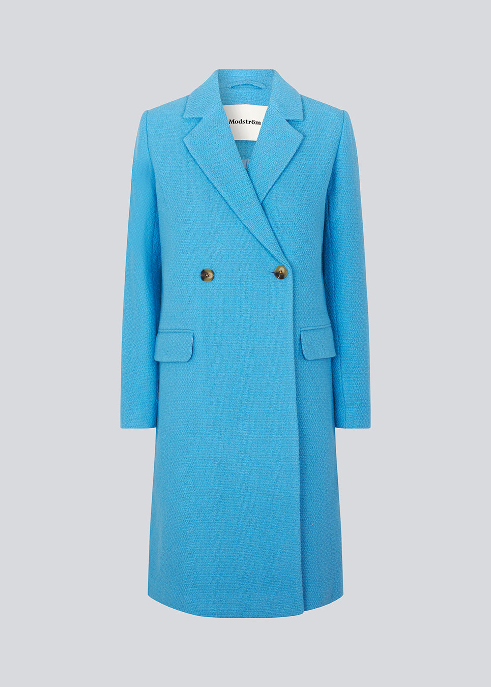 Double-breasted coat with lapels and buttons in front. EdinMD coat has a midi length with long sleeves, front pockets with a flap and single back vent. Lined. The model is 175 cm and wears a size S/36.