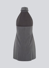 Short fitted dress in grey pinstripe with a halterneck. EmiliaMD halterneck dress has a button closure at the neck and an invisible zipper at the back.