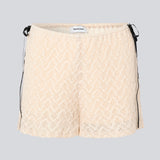 Cute shorts in a soft lace material in light beige/white. EmiliaMD lace shorts have lining and elastic at the waist. The shorts have two black bows on hips as a cool contrast to the light beige.