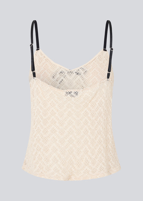 Cute Loose top is in light beige/white soft lace material. EmiliaMD lace top has small adjustable black straps and a black bow detail in front.