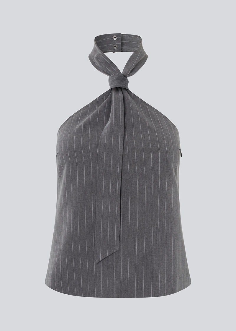 Fitted top in grey pinstripe with a cool tie detail. EmiliaMD tie top has an invisible zipper at the side and a button closure at the neck.