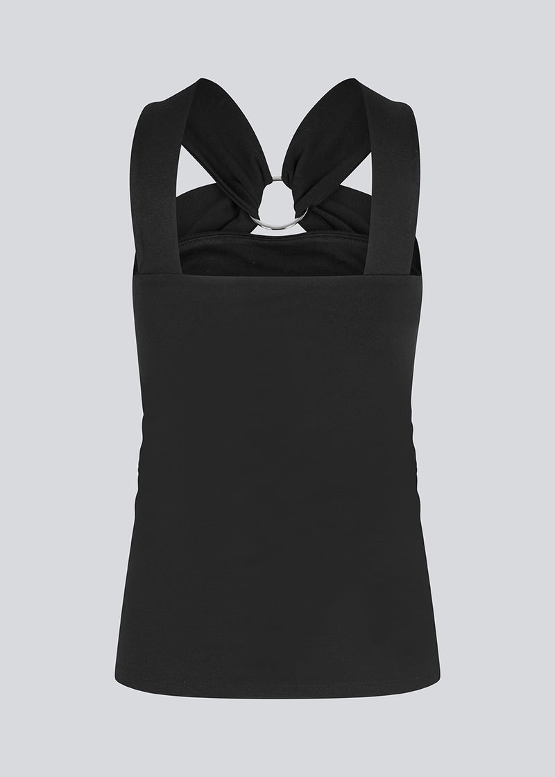 Fitted black top in an elastic material. EmiliaMD top has a detailed metal ring at the chest and wide straps.
