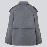 Cropped double-breasted wool coat with hidden buttons. EsmundMD jacket, in the colot Dark Grey Melange, has classic coat details with raglan sleeves and an high yoke at the back. Lined. The model is 175 cm and wears a size S/36.