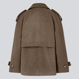 Cropped double-breasted wool coat in a brown color with hidden buttons. EsmundMD jacket has classic coat details with raglan sleeves and an high yoke at the back. Lined. The model is 175 cm and wears a size S/36.