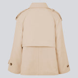 Cropped double-breasted wool coat with hidden buttons. EsmundMD jacket, in the color Summer Sand, has classic coat details with raglan sleeves and an high yoke at the back. Lined. The model is 175 cm and wears a size S/36.