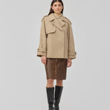 Double-breasted wool coat in a beige corlor with hidden buttons. EsmundMD jacket has classic coat details with raglan sleeves and a high yoke at the back.