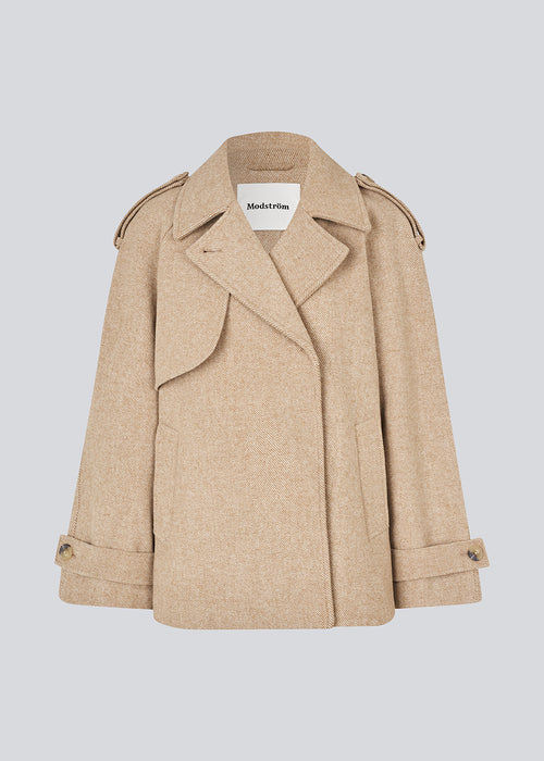 Double-breasted wool coat in a beige corlor with hidden buttons. EsmundMD jacket has classic coat details with raglan sleeves and a high yoke at the back.