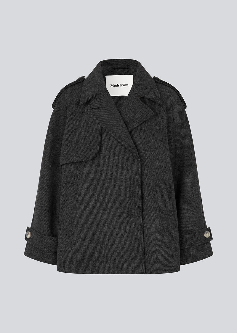 Double-breasted black wool coat with hidden buttons. EsmundMD jacket has classic coat details with raglan sleeves and a high yoke at the back.